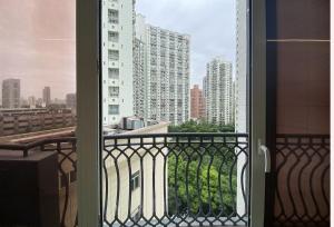 an open window with a view of a city at Tyms APT Hengshan RD Near IAPM K11 Line9 in Shanghai