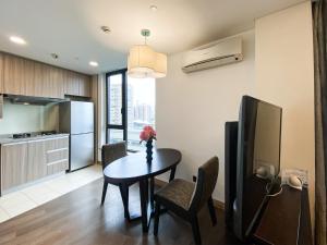 a kitchen and dining room with a table and chairs at Tyms APT Hengshan RD Near IAPM K11 Line9 in Shanghai