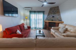 a living room with two couches and a fireplace at Cortijo Pinar 2 in Níjar
