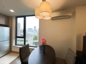 a kitchen with a table and a large window at Tyms APT Hengshan RD Near IAPM K11 Line9 in Shanghai