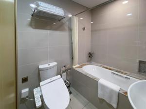 a bathroom with a toilet and a bath tub at Tyms APT Hengshan RD Near IAPM K11 Line9 in Shanghai