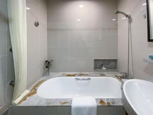 a bathroom with a tub and a sink at Tyms APT Hengshan RD Near IAPM K11 Line9 in Shanghai