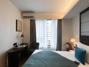 a hotel room with a bed and a window at Tyms APT Hengshan RD Near IAPM K11 Line9 in Shanghai