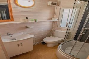 une salle de bain avec toilettes, lavabo et douche dans l'établissement Holiday Home Dziwnówek near Baltic Sea, à Dziwnówek