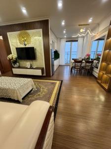 a living room with a bed and a dining room at HOMESTAY CAO CẤP TẠI NEWLIFE HẠ LONG 2PN in Ha Long