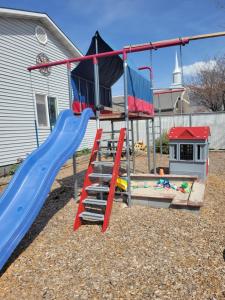 a playground with a slide in a yard at Monopoly Place in American Fork