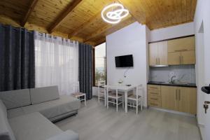 a living room with a couch and a table at Garden Vila Ermali in Ksamil