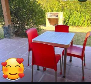 a table and four chairs with a smiley face painted on it at das gelbe haus in Los Reartes