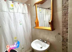 a bathroom with a sink and a mirror at das gelbe haus in Los Reartes