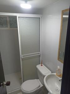 a bathroom with a toilet and a sink at Confortable y comodo apartamento in Cartagena de Indias +8 photos