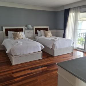 โรงแรม ริเวอร์บรีซ เชียงแสน River Breeze Chiangsean客房内的一张或多张床位