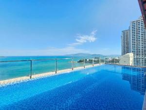 a swimming pool with a view of the ocean at Putin Hotel Nha Trang in Nha Trang