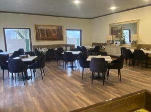 a restaurant with tables and chairs in a room at The Guest House Hunza in Karimabad Hunza