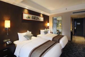 Letto o letti in una camera di Millennium Hotel Fuqing