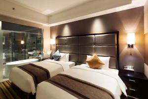 Letto o letti in una camera di Millennium Hotel Fuqing