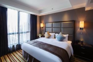 Letto o letti in una camera di Millennium Hotel Fuqing