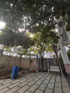 a patio with a bench and a tree at lizhome in Da Nang