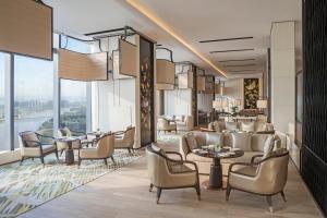 a rendering of a hotel lobby with tables and chairs at Jumeirah Nanjing in Nanjing