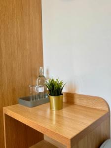 a potted plant sitting on top of a wooden table at Stay 45A in London