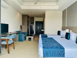 a hotel room with a large bed and a desk at Negombo Ocean Breeze Luxury Studio by Serendib Vacation in Negombo