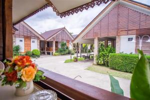 a view from a window of a house with a courtyard at Ruentara Resort & Villa in Buriram