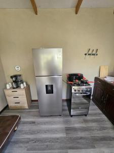 a kitchen with a stainless steel refrigerator and a stove at Casa Torogoz in Santa Cruz Verapaz +12 photos