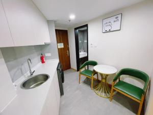 a kitchen with a sink and a table and chairs at Clivia Hotel in Shanghai +26 photos