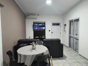 a room with a table and chairs and a tv at DS confort in General Pico
