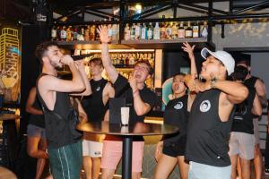 a group of people dancing in a bar at Mad Monkey Manila in Manila