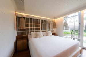 Postel nebo postele na pokoji v ubytování Hotel Lumi Gili Trawangan