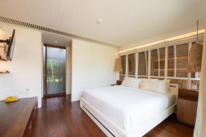 Postel nebo postele na pokoji v ubytování Hotel Lumi Gili Trawangan