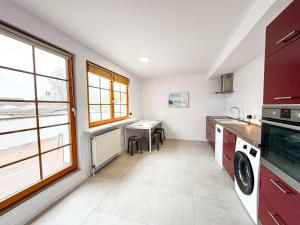 a kitchen with a sink and a table in it at Large Apartment for Large Groups south of Berlin in Großbeeren +18 photos