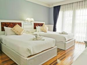 โรงแรม ริเวอร์บรีซ เชียงแสน River Breeze Chiangsean客房内的一张或多张床位