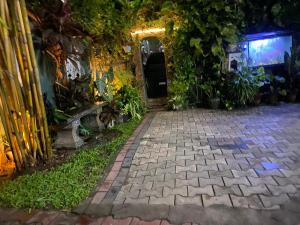a brick walkway leading into a building with plants at JJ Villa & Tours in Aluthgama