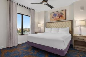 a bedroom with a large bed and a large window at Club Wyndham Bonnet Creek in Orlando