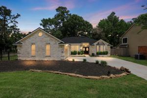 a house with a landscaping in the front yard at Woodbridge Bungalow - Private Villa Near IAH - Pool in Houston