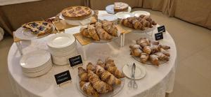 a table with plates and pies and pastries on it at Villa Cagnola in Varese