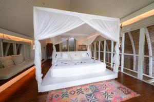 Postel nebo postele na pokoji v ubytování Hotel Lumi Gili Trawangan