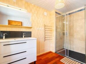 a bathroom with a white sink and a shower at Maison à Génos pour 8, proche lac, jardin et poêle à bois - FR-1-695-73 in Génos +9 photos