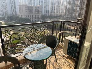 a table and chairs on a balcony with a view at Luxuriesstay in Omaxe Hazratganj in Nilmatha +10 photos