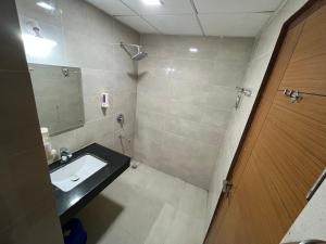 a bathroom with a sink and a mirror at Luxuriesstay in Omaxe Hazratganj in Nilmatha