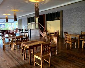 a dining room with wooden tables and chairs at La Paloma Hostal in Moyogalpa +22 photos