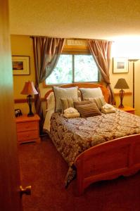 a bedroom with a large bed and a window at Snowater Condo 84 - large condo with private sauna and soaker tub in Bellingham