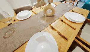 a wooden table with a toilet and glasses on it at Arcoris Mont Kiara in Kuala Lumpur +71 photos