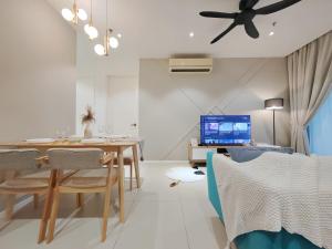 a living room with a dining room table with a ceiling fan at Arcoris Mont Kiara in Kuala Lumpur