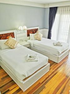 โรงแรม ริเวอร์บรีซ เชียงแสน River Breeze Chiangsean客房内的一张或多张床位