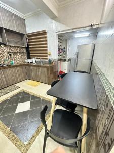a room with a table and chairs in a kitchen at Harryna Homestay Damansara Damai in Petaling Jaya +8 photos