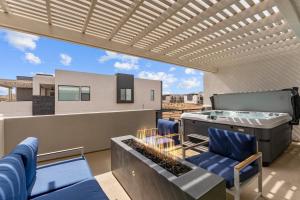 a balcony with a pool table and blue chairs at Starlight Sanctuary townhouse in St. George