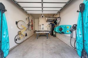 a garage with a bike and a table in it at Starlight Sanctuary townhouse in St. George +62 photos