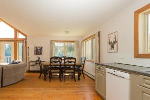 a kitchen and dining room with a table and chairs at Pet Friendly 3 Bdrm Home with Hot Tub by StayIn in Fernie